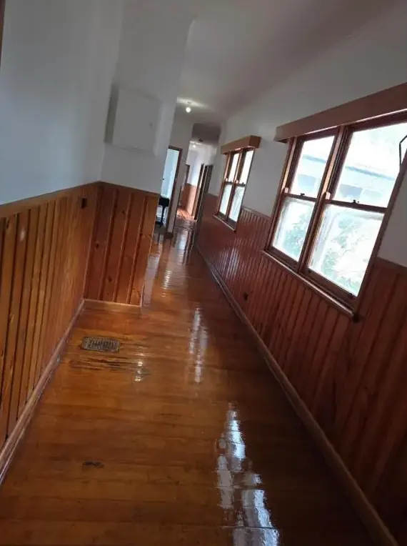 Interior hallway with polished timber floor and timber-lined walls